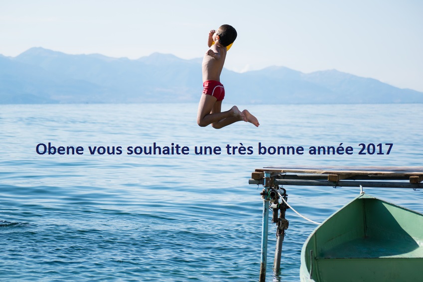 Young boy jumping into lake